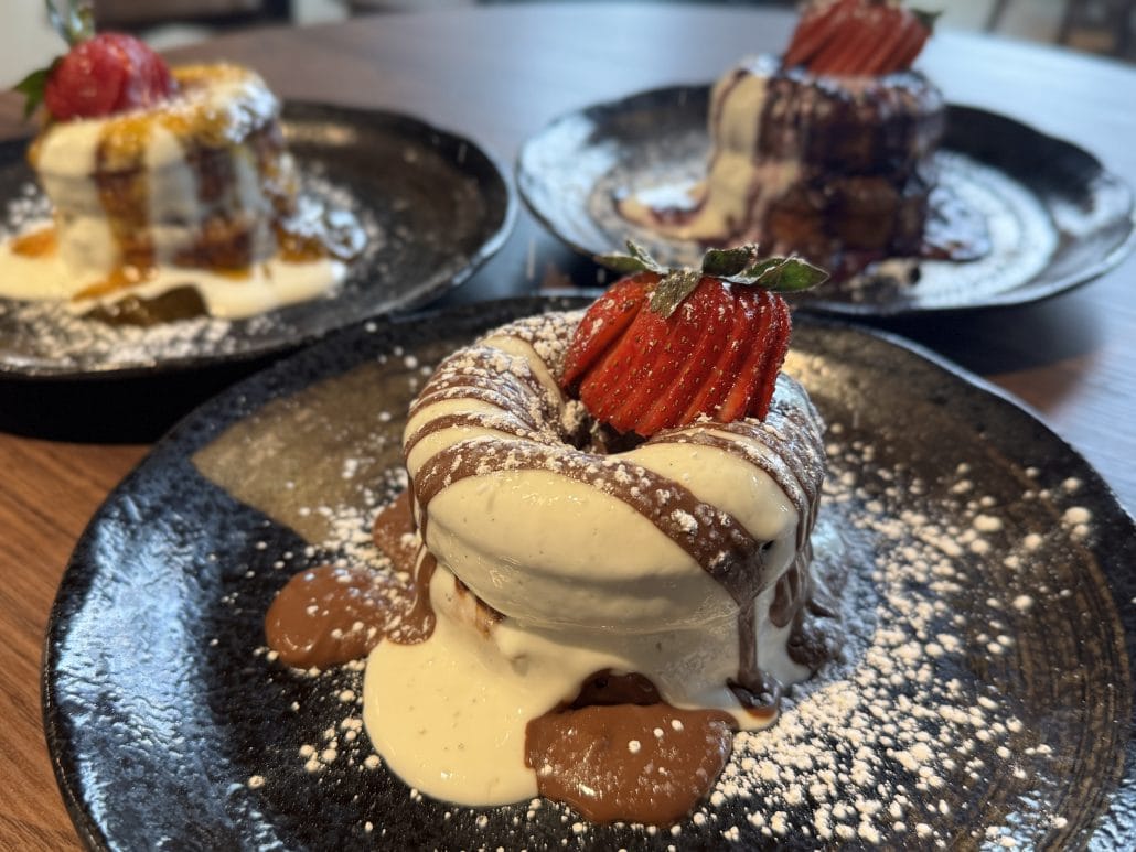 Delicious chocolate and vanilla ice cream dessert with strawberries and caramel sauce.