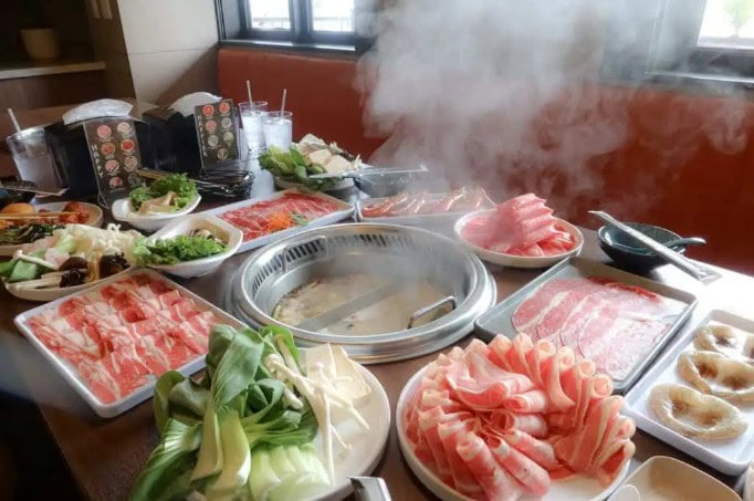 Lynnwood hot pot restaurant with fresh meats and vegetables for cooking.